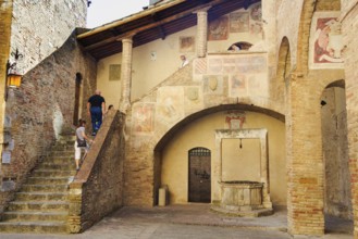 Tourists visit the Museo Civico, San Gimignano, Tuscany, Italy, Europe
