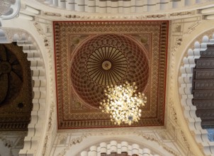 Casablanca, Morocco, 29 March, 2024: detail view of an ornate cedarwood ceiling and chandelier