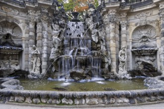 Fountain with faunus statues and streaming water at Zwinger palace, Dresden, Germany, Europe