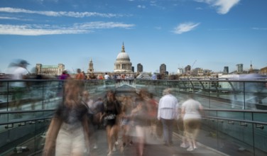 London, UK, July 5, 2019: People walking on the millennium bridge and Saint Paul Cathedral in