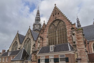 Impressive gothic church with high tower under a cloudy sky, Amsterdam, Netherlands