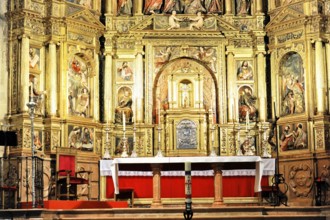 Baroque altar in the nave, richly decorated with golden details and religious paintings, Iglesia de