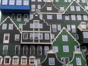 Detail of modern green hotel building as with many stacked small traditional buildings of Inntel