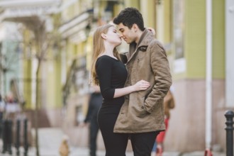 Urban modern young love couple walking romantic talking talking, holding hands on a date. Young