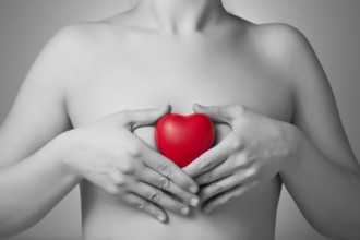 Woman holding a red heart shape