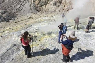 KAMCHATKA, RUSSIA, SEPTEMBER 11, 2013: Group photographers takes picture volcanic landscape, hot