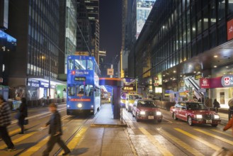 Unrecognizable people, moving, blurred. HongKong, is people anthill ! Double-deck, is tram -left,