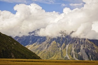 Mount Cook Range under blue sky and thick clouds on the South Island of New Zealand