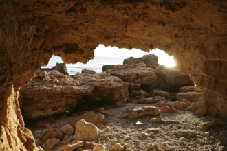 Cave entrance view from interior with light coming in, beach