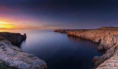 Landscape view of cliffs and rugged shorelina at Pont d'en Gil in northeastern Menorca near