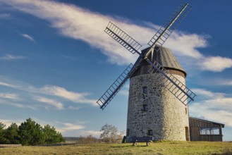 A windmill in the field in the daytime