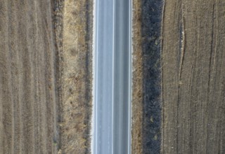 Drone aerial of countryside rural empty road. Dry land