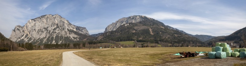 Lamingtal cycle path between farmland in spring, Pribitz mountain and Meßnerin mountain, in the