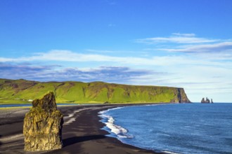 Cape Dyrholaey. The southern edge of Iceland. Beach with black volcanic ash Reinisfjara. Giant