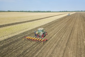 Farmer seeding crops at field. Seeding Aerial View