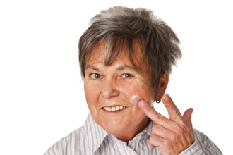 Senior woman with cream pot cropped on white background