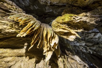 Inside of a beautiful colourful cave. Flowstones, stalactites and stalagmites lighted in different