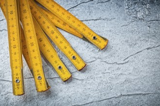 Wooden meter on metallic background top view construction concept