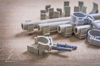 Big Composition Polypropylene Fixators And Pipe With Clips On Wooden Board