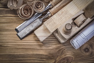 Blueprint shaving plane flat chisels wooden bricks shavings on wood board