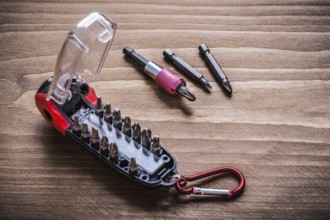 Toolbox with interchangeable stainless screwdriver heads on wooden board