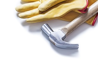 Claw hammer and yellow leather gloves isolated