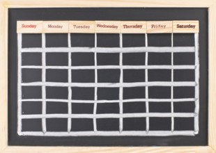 Monthly calendar with week words print on wood on blackboard