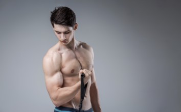 Muscular fit young male antique perfect muscles six packs of abs and bare chest. Bodybuilder model