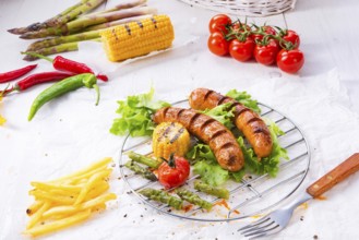 Grilled krakauer sausage with boiled corn and green salad