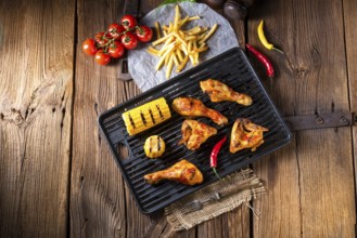 Rustic Grilled chicken wings, legs, and spicy corn