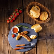 Rustic bratwurst with ketchup and fresh rolls