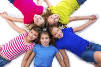 Happy kid friend girls group smiling aerial view lying on circle over white background holding