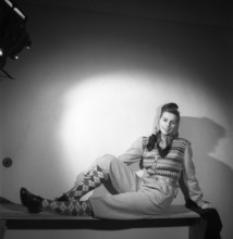 Fashion of 1946. A woman pictured wearing the typical fashion of the postwar era. She is dressed in
