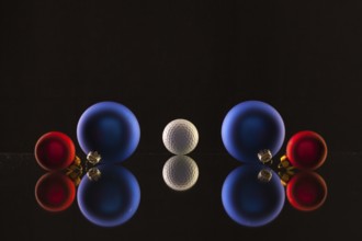 Golf ball and Christmas decoration on the glass table