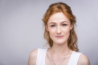 Portrait of a beautiful young woman of European, Caucasian nationality with long red hair and