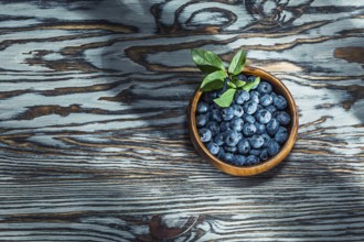 Ripe huckleberries in wooden bowl