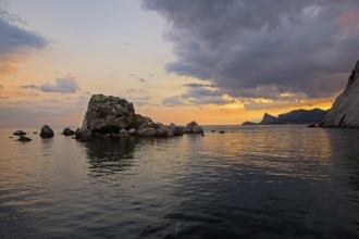 Sunset on the Black Sea coast. View from the embankment of Sudak in the direction of Novyy Svet.
