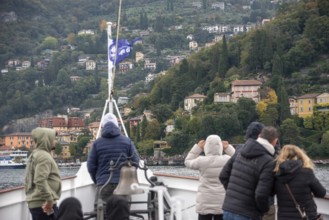 VARENNA, ITALY, OCTOBER 05, 2023, Tourists waiting for the ferry to dock at the harbor of Varenna,