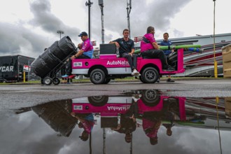 Crew members of Andretti Autosport Honda prepare their race car for the Big Machine Music City