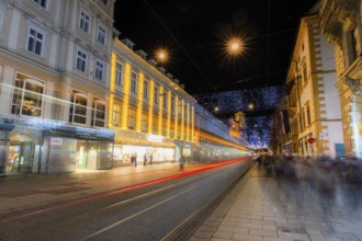 Advent atmosphere, Christmas illuminated Herrengasse, light tracks of a tram, Graz, Styria,