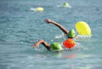 Athletes swimming free style in the sea during race competition. Aquathlon Swimmer in the ocean