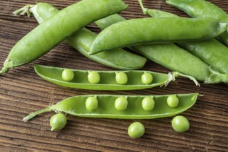 Few green peas on black background