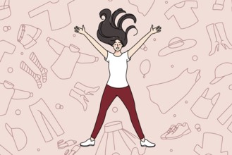Overjoyed young girl lying among clothes excited with shopping and purchase. Smiling woman