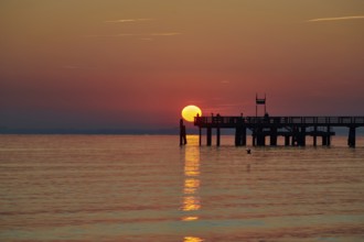 Red sunrise over the sea at the pier of the Baltic Sea resort, Boltenhagen, Mecklenburg-Vorpommern,