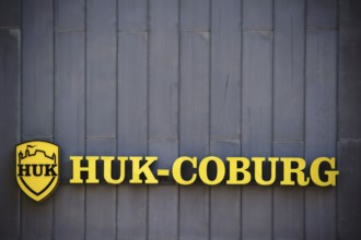 Mainz, Germany - July 06, 2017: The yellow company sign and logo of the insurance company HUK