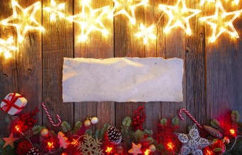 Christmas glow stars and fir white paper parchemin copy space on vintage wood