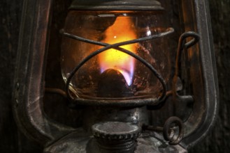 Old gas lantern on wood at darkness