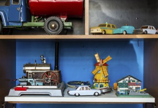 Old vintage toys on shelf. Collection of vintage cars toys in a shop. Bright colours