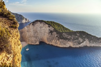 Summer holidays in Greece. Magic island on the Mediterranean Sea. The sky glows a warm sunset. The