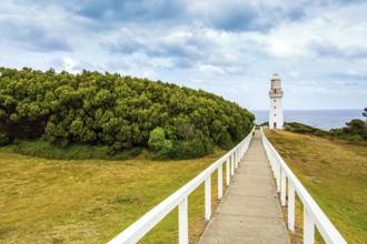 Magnificent lighthouse on the ocean shore. The Great Ocean Road runs along the Pacific coast of
